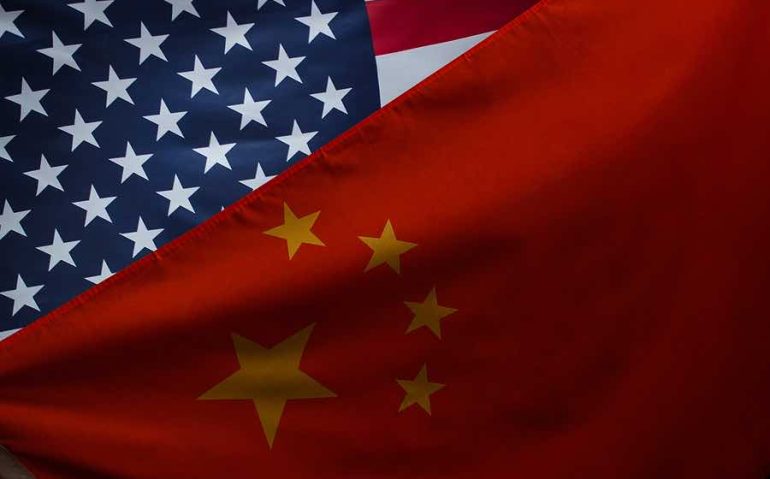 Close-up shot of waving flags of USA and China