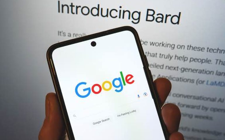 Google launches Bard AI. Google search bar on a phone in hand with release information on background. Google Bard AI vs OpenAI ChatGPT. Warsaw, Poland - February 8, 2023.