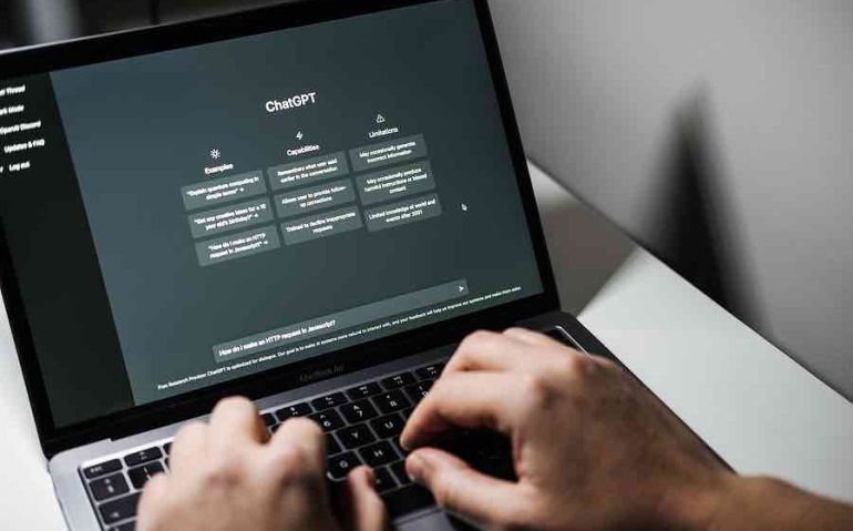 Screen with ChatGPT chat with AI or artificial intelligence. Man search for information using artificial intelligence chatbot developed by OpenAI. Warsaw, Poland - December 02, 2022